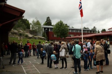 Foreldre og barn lytter til Rektor tale til f&oslash;rsteklassingene